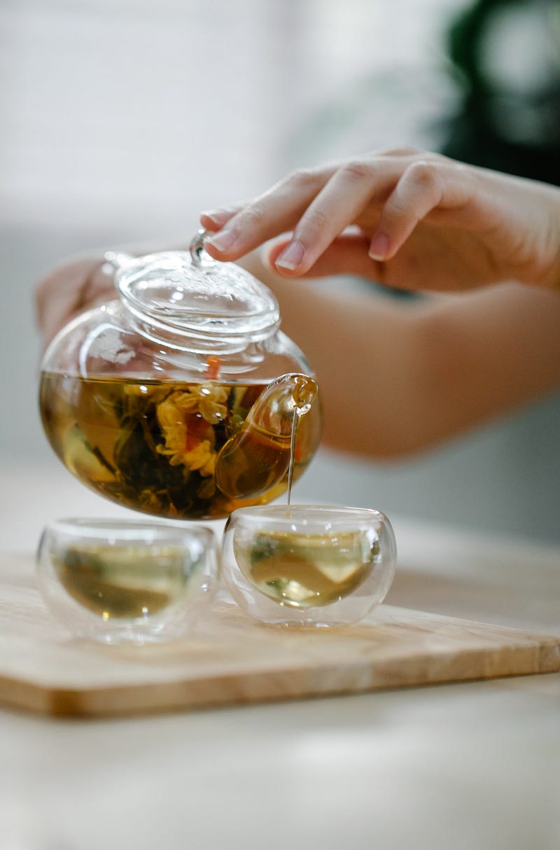 Various types of tea stored in elegant containers.