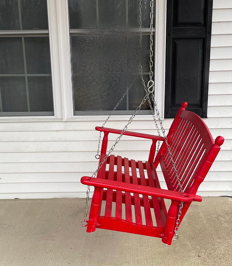 A beautifully crafted cedar porch swing inviting relaxation